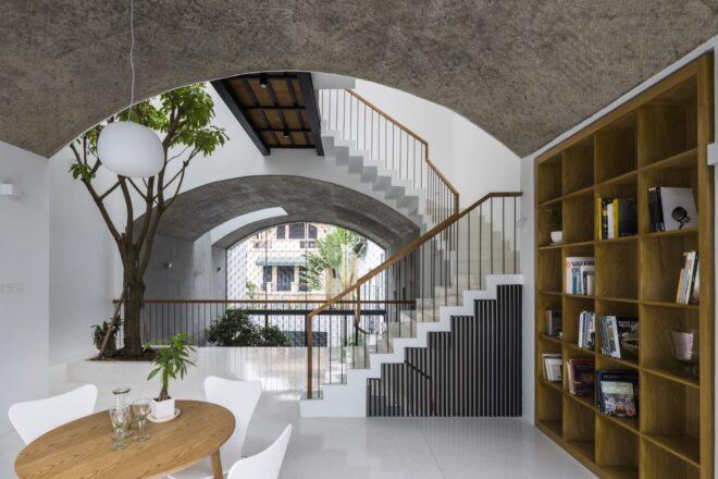 built-in wood bookcase near white staircase