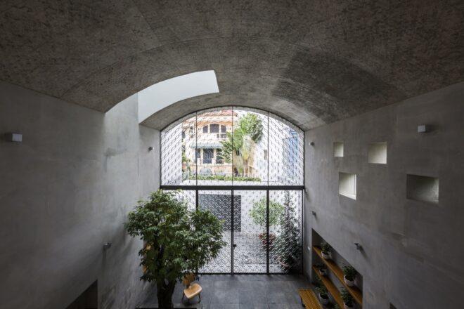 trees under concrete archway