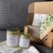 two candles and paper sandwich bags inside a cardboard box