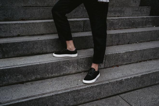 person on steps wearing black sneakers