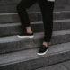 person on steps wearing black sneakers