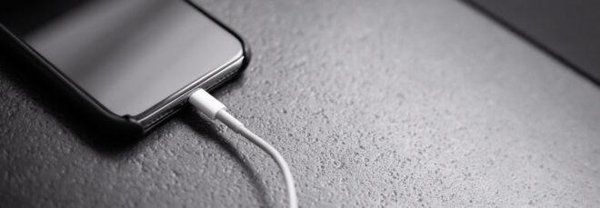 Apple iPhone plugged into charger