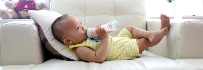baby drinking from plastic bottle