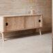 light wood credenza against tan wall