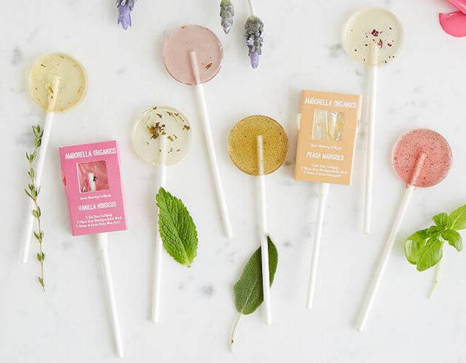 lollipops, leaves and flowers on marble background