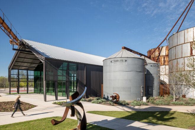 silos beside black gabled building