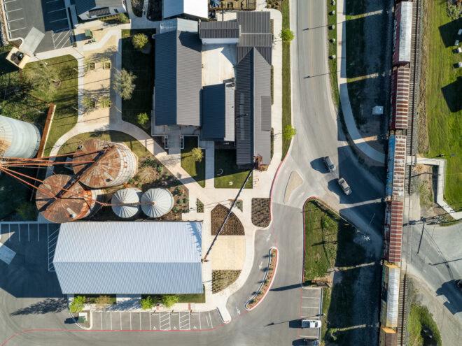 aerial view of multiple gabled buildings and silos