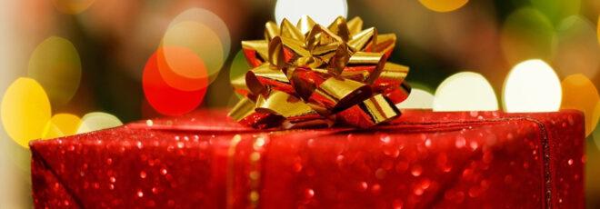 a close-up of a red-wrapped gift with a gold bow.