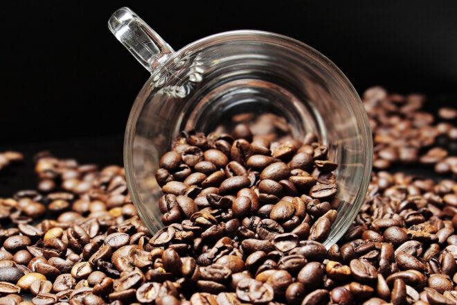 glass coffee cup filled with coffee beans