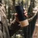 Person holding black reusable coffee cup