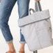 person holding gray backpack
