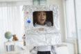 kid wearing aluminum-foil wrapped box as a robot costume