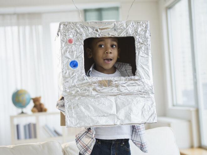 kid wearing aluminum-foil wrapped box as a robot costume