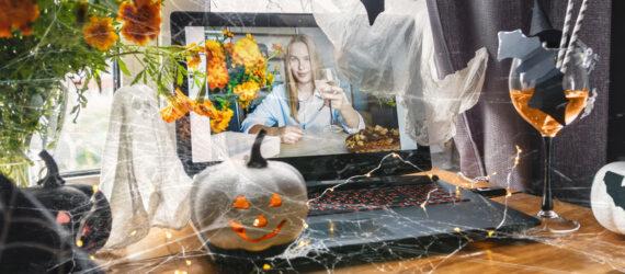 person video-chatting with someone with pumpkins and flowers on table
