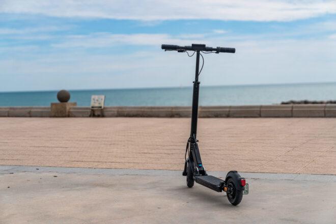 black e-scooter near a beach