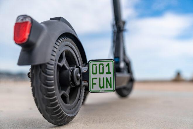 Tiny scooter license plate that reads "001 Fun"