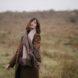 person wearing cashmere scarf and brown coat