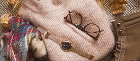 pink sweater, brown glasses, gold watch, brown boots and plaid scarf flat lay