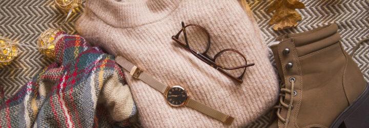 pink sweater, brown glasses, gold watch, brown boots and plaid scarf flat lay