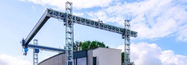 A 3D-printing construction rig, with a concrete structure underneath it.