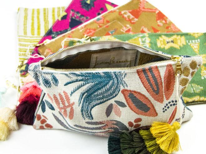 five clutch bags in yellow, pink, orange, green and white prints.