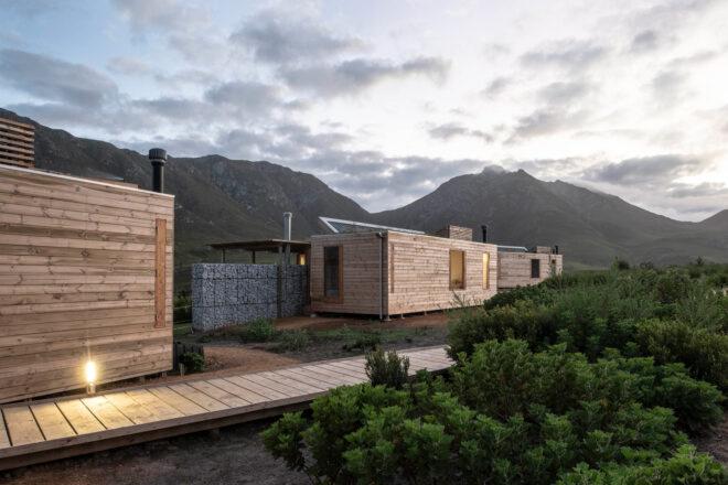 wood boardwalks connecting stone and wood cabins
