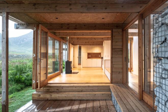 wood cabin with glass door opening to the inside