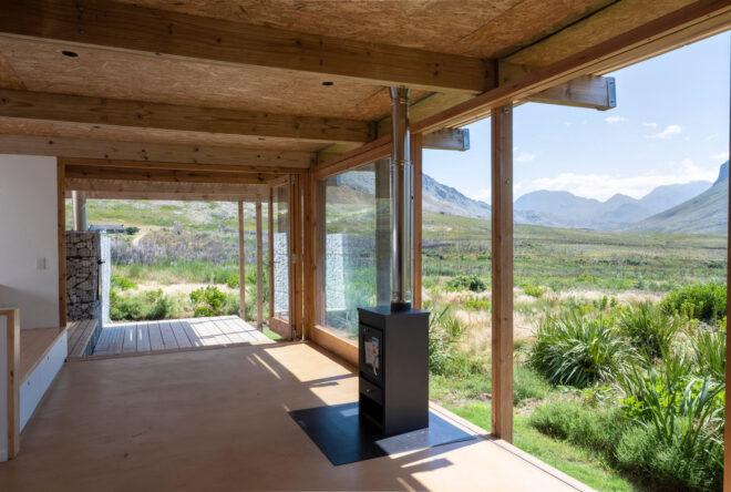 covered wood deck facing mountainous landscape