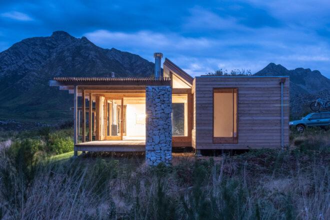 stone and wood cabin at night