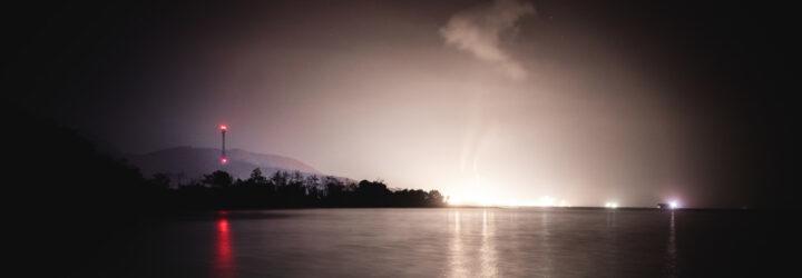 lights shining and casting a glow on a night sky