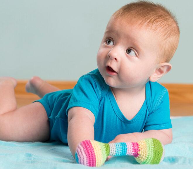 baby with colorful rattle