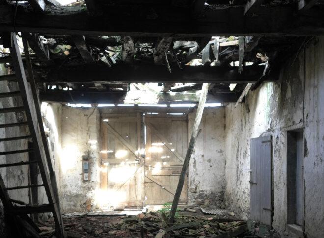 The inside of a crumbling old farmhouse.