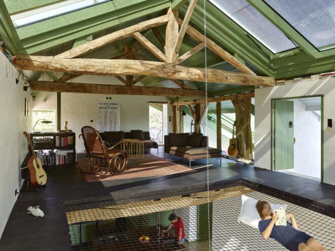 The second story of a home, with a cutout for a hammock area.