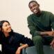 Two people sit next to each other in dark bleu and green loungewear.