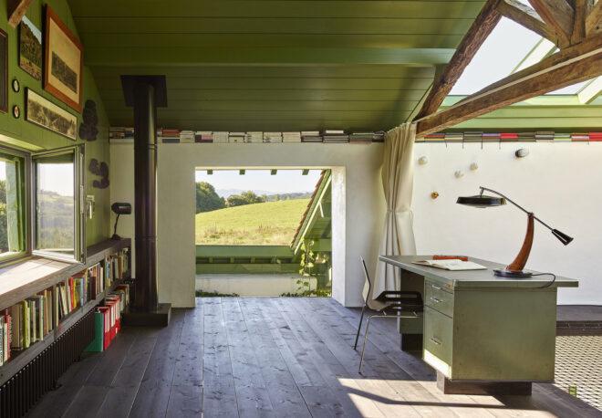 An interior office space with green painted roof.