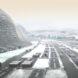 A cold, mountainous landscape with various geometric structures places around dark lanes.