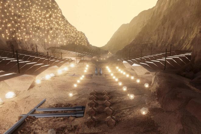 A valley between mountains with lights places all around to light up structures on either side.