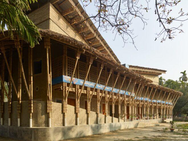 mud brick and bamboo building with thatched roof