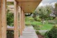plants and narrow path next to wood and glass home