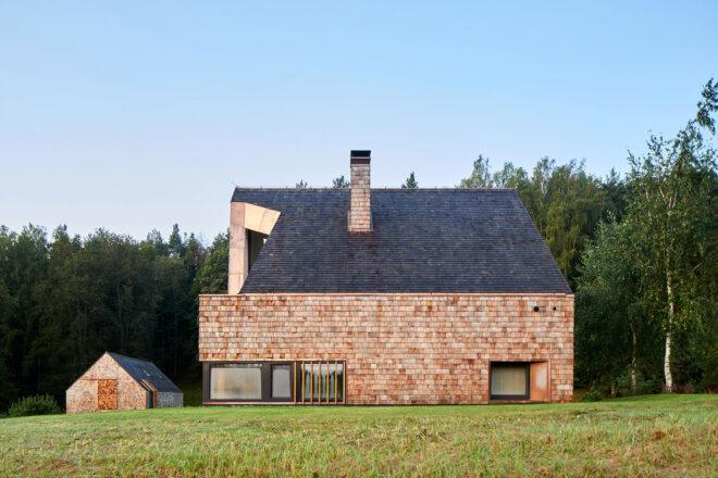cedar home with smaller cedar-clad building next to the home