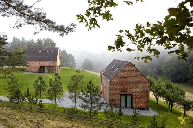 aerial view of two wood buildings with gabled roofs