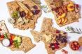 Cutting boards in the shapes of states, with fruits arranged on them.