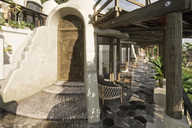 large wood door on rammed earth dome home
