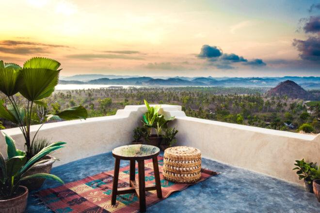 small pouf seat and table on open balcony area with ocean views