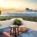 small pouf seat and table on open balcony area with ocean views