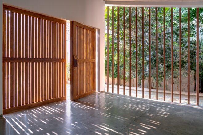 slatted wood doors opening to an entryway