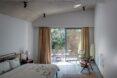 large bed in white room with sliding glass doors