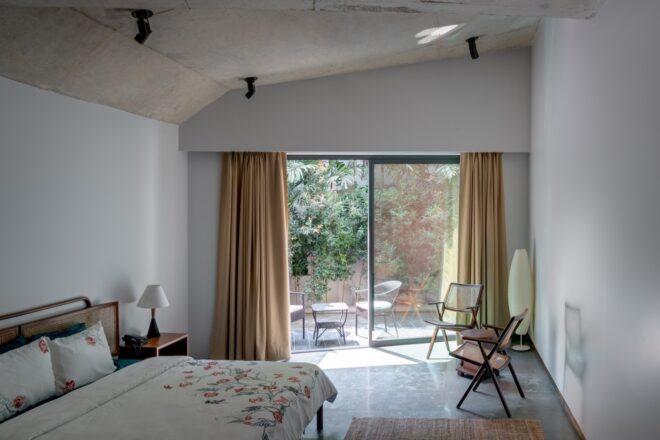 large bed in white room with sliding glass doors