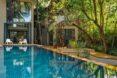 long swimming pool near coconut trees