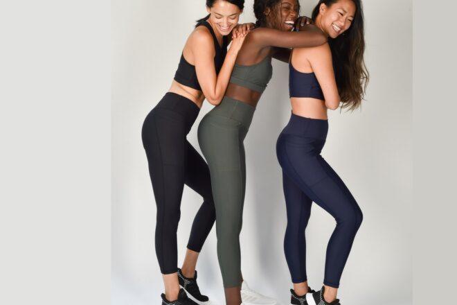 Three people wearing black, olive and purple athletic clothes.